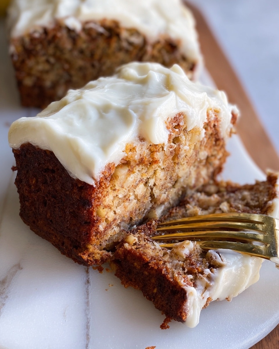 A moist loaf of banana bread is shown sliced open, revealing its dense and textured inside with bits of banana visible throughout. The bread has a golden-brown crust with slightly darker edges and crumbs around the cut area. On top of the loaf, there is a thick layer of creamy, white frosting that is spread unevenly with soft swirls. The bread is placed on a dark wooden board, set against a white marbled surface. Photo taken with an iphone --ar 4:5 --v 7